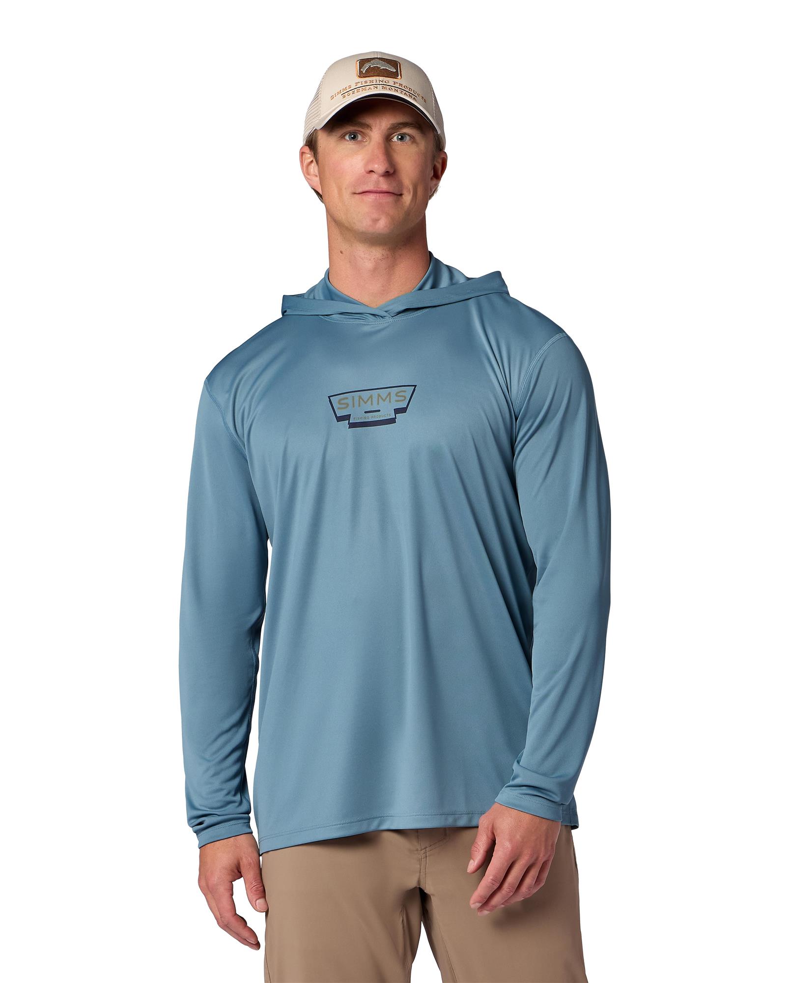 Model wearing Simms Artist Series Tech Hoody lightweight fishing sun shirt with hood