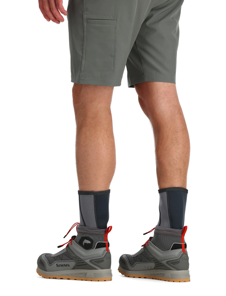 Rear view of model wearing Simms Neoprene Wading Socks with boots.