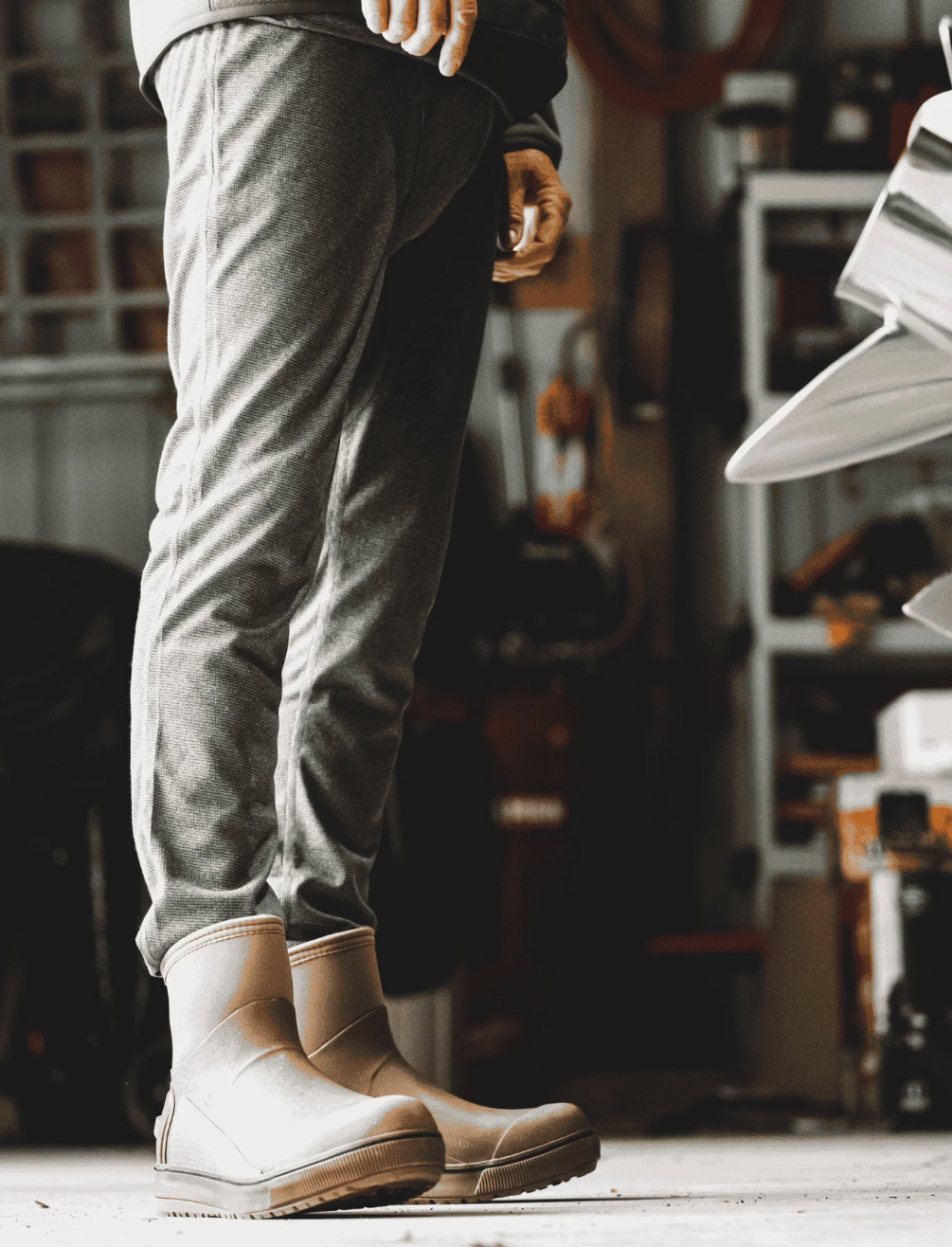 Angler wearing Simms Strata 160 Baselayer Bottom with  boots