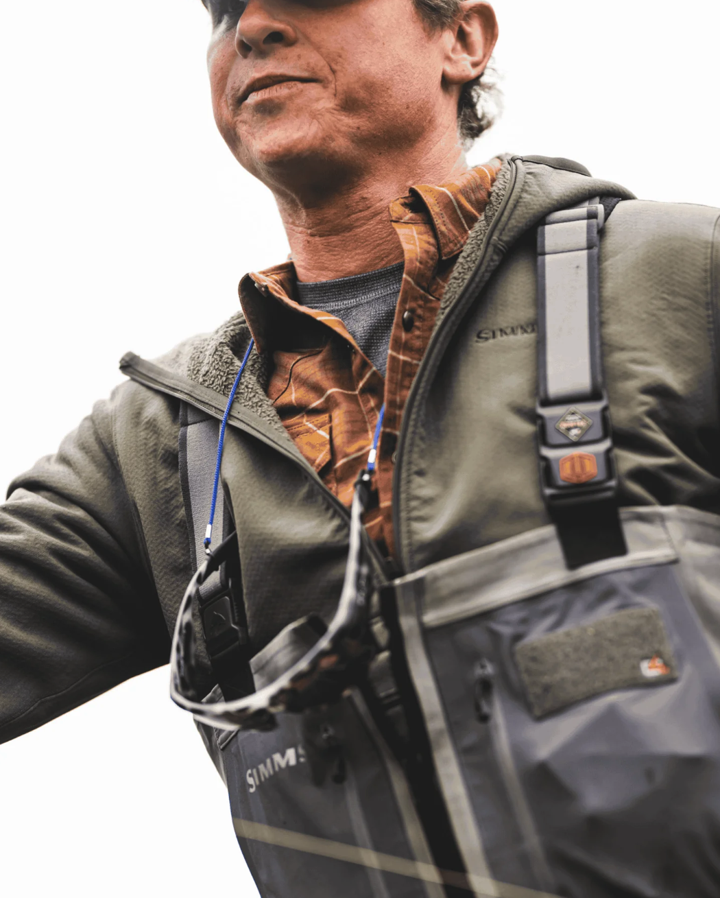 Man wearing waders and Simms Strata 330 Half-Zip Midlayer Hoody