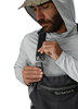 Man clipping strap of Simms Flyweight Packable Waders