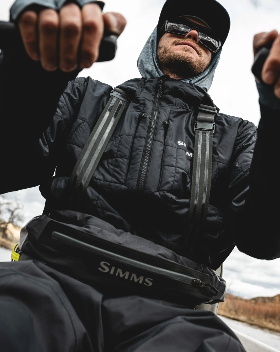 Man rowing boat in Simms Flyweight Packable Waders