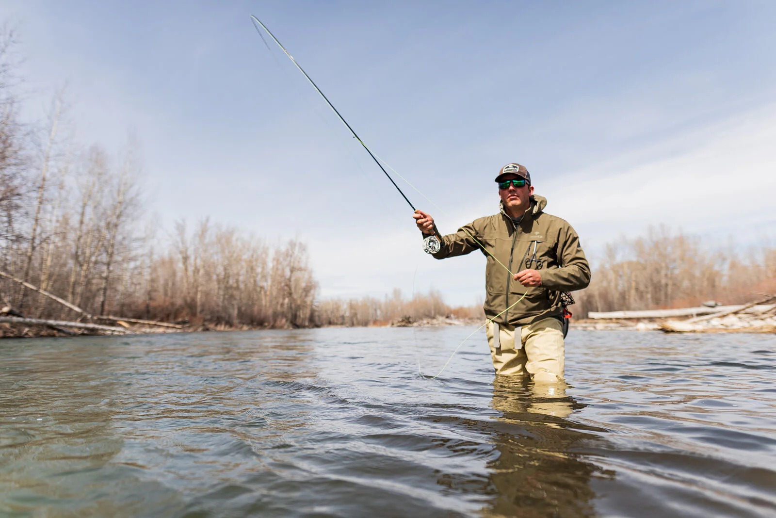 - Skwala Backeddy fleece-lined softshell jacket worn while wading and fly fishing in variable weather