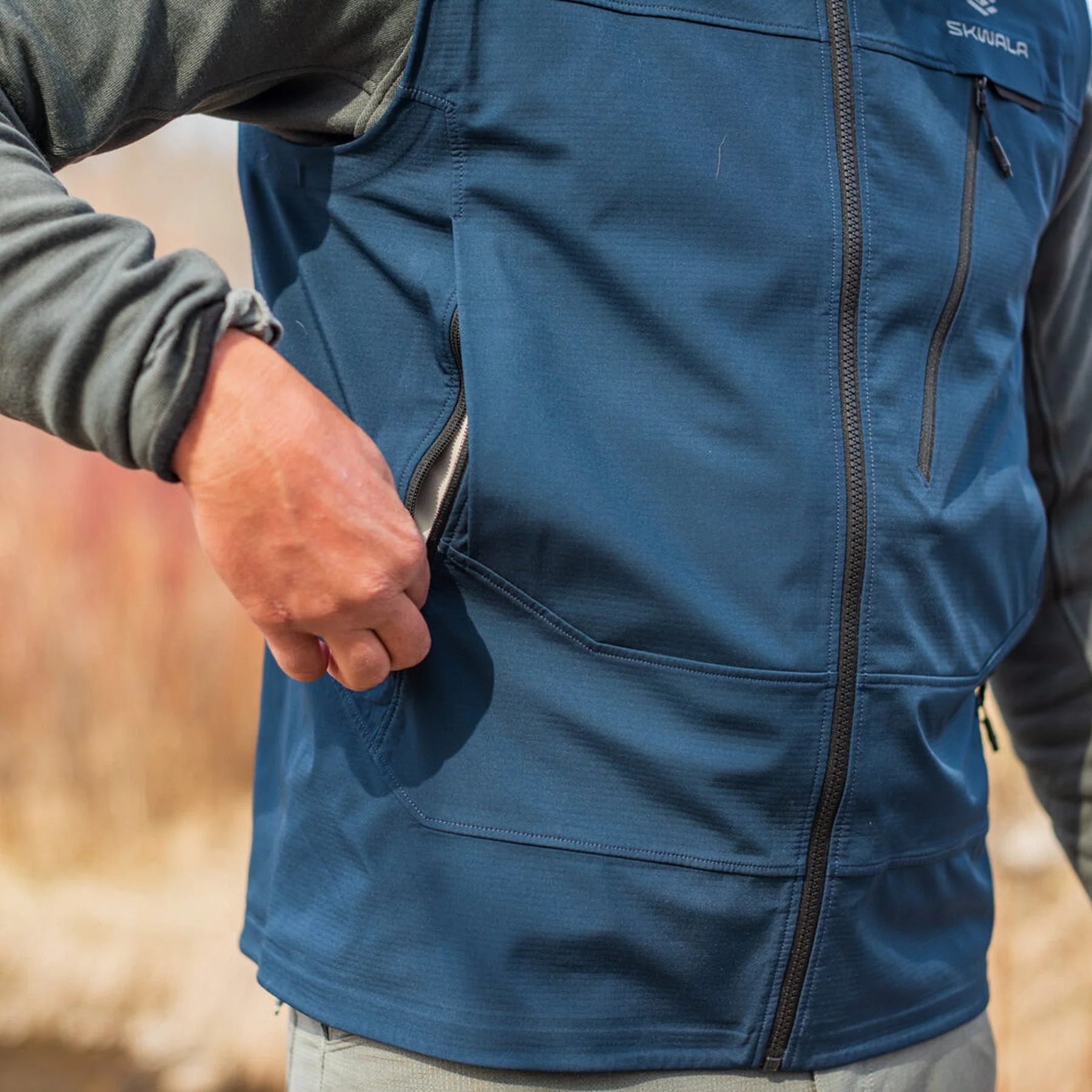 Zippered hand pocket on Skwala Backeddy windproof fishing vest for secure outdoor storage