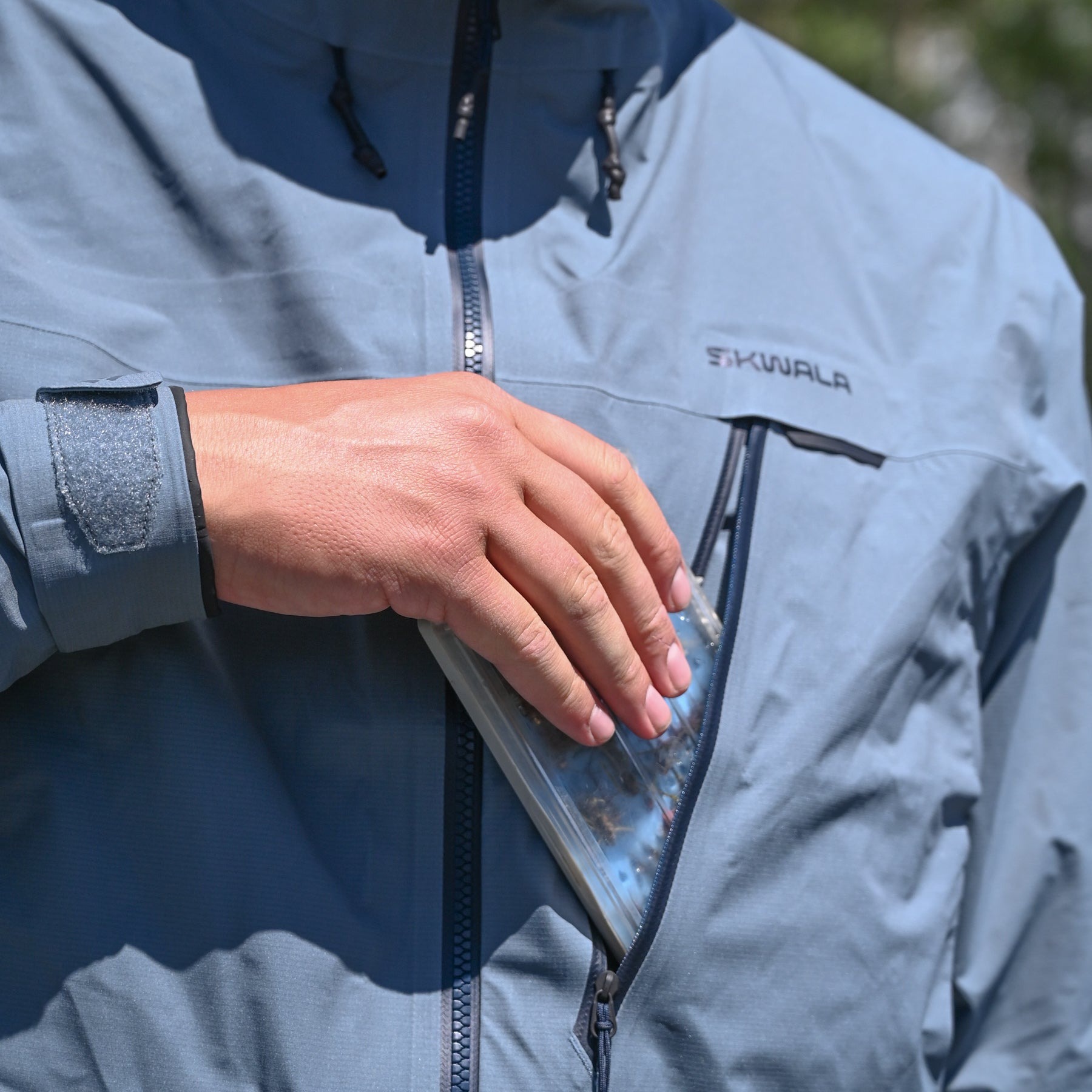 Skwala Carbon Rain Jacket angled chest pocket detail with waterproof zipper fly fishing rain shell