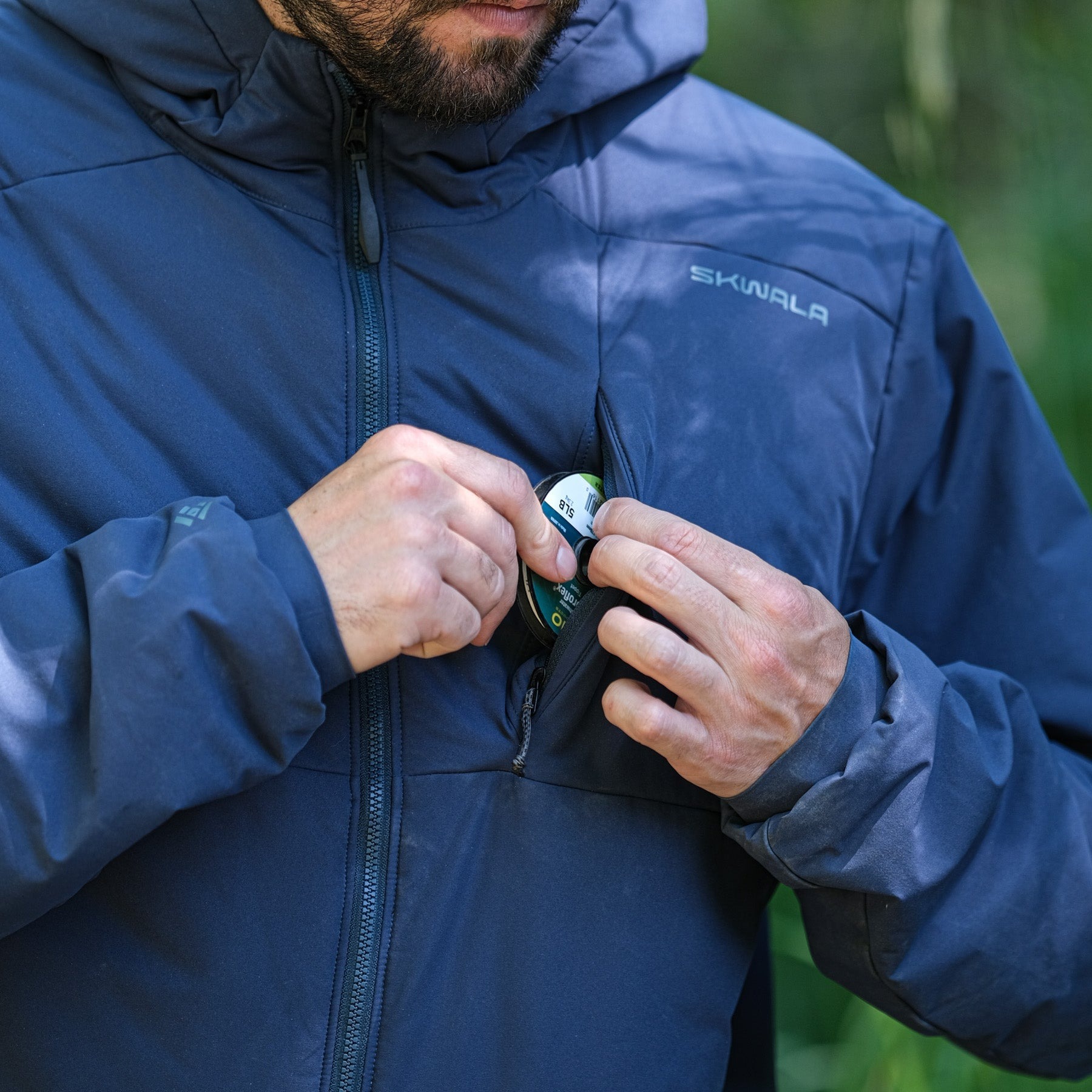 Skwala Fusion 3/2 Puffy Jacket chest pocket detail with fly fishing tippet spool storage