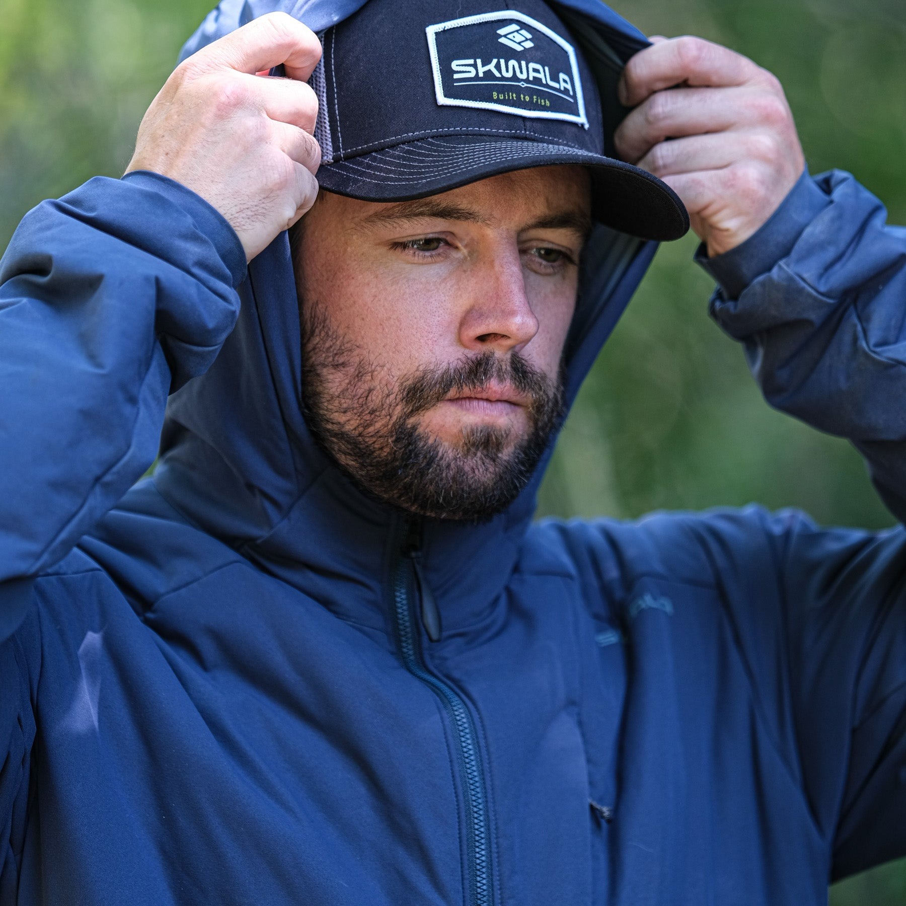 Skwala Fusion 3/2 Puffy Jacket hood up worn by angler cold weather fly fishing insulation layer