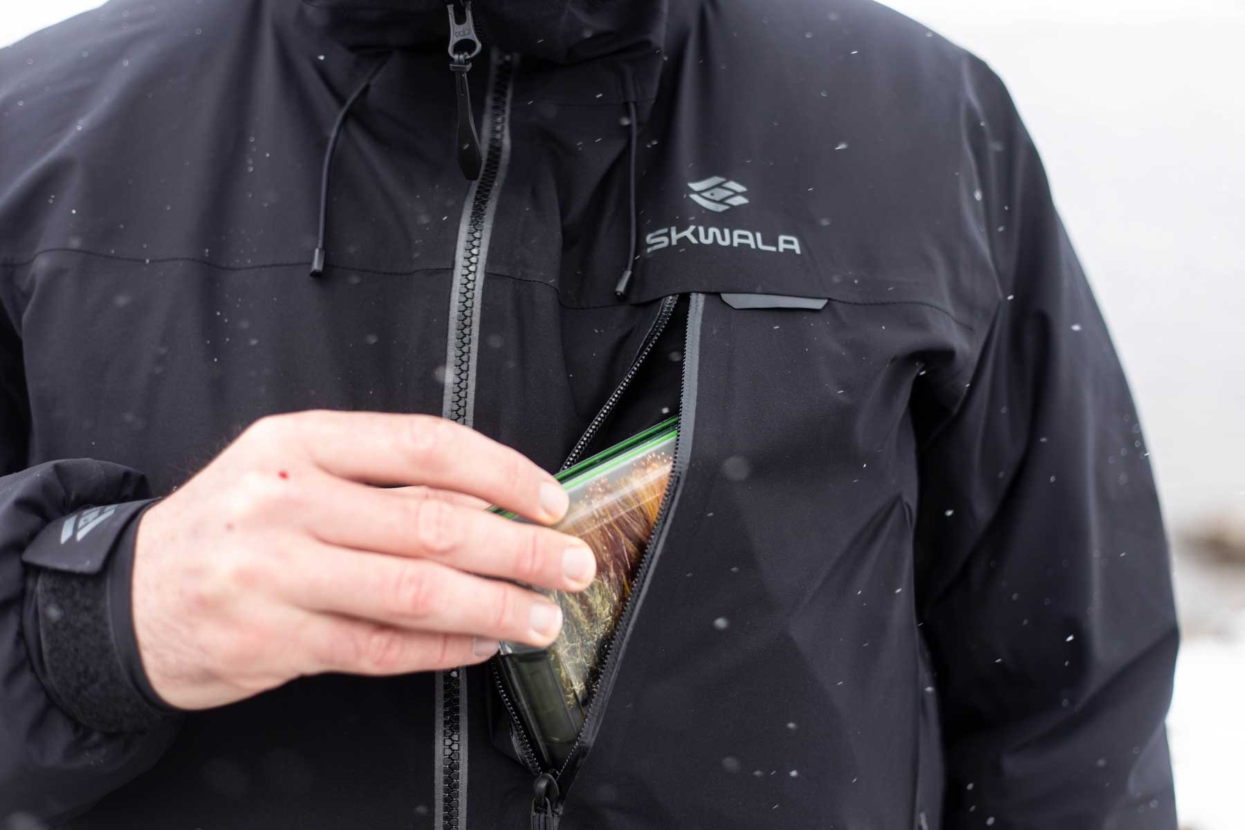 Waterproof winter fly fishing jacket chest pocket designed for secure access to fishing essentials