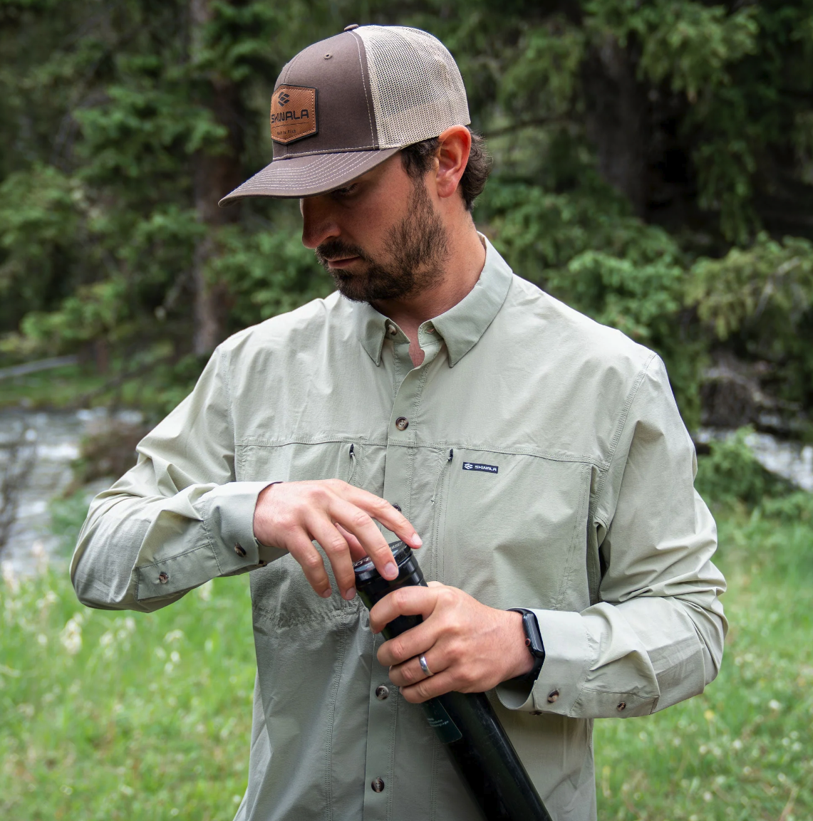 Angler wearing Skwala Sol Breeze Shirt putting rod away