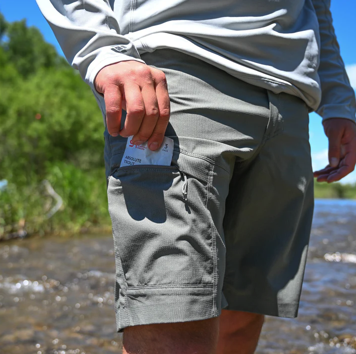 Angler pulling leader pack from pockets of Skwala Sol Shorts Charcoal color