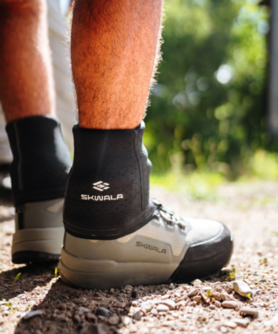 Man standing in boots with Skwala Backeddy Wet Wading Sock on