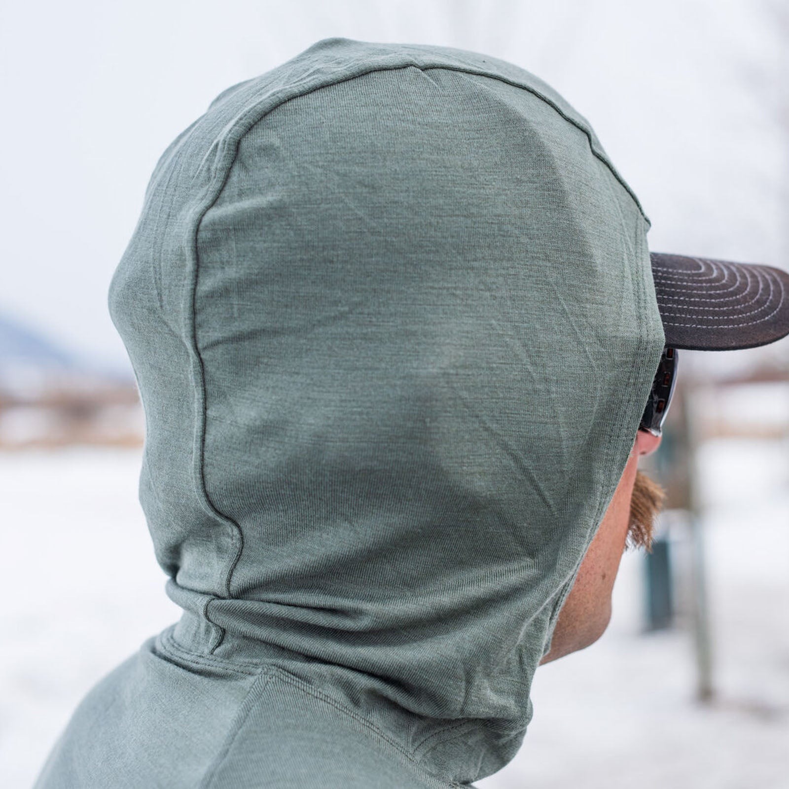 Skwala Thermo 150 Hoody scuba hood design worn by angler for sun protection while fly fishing