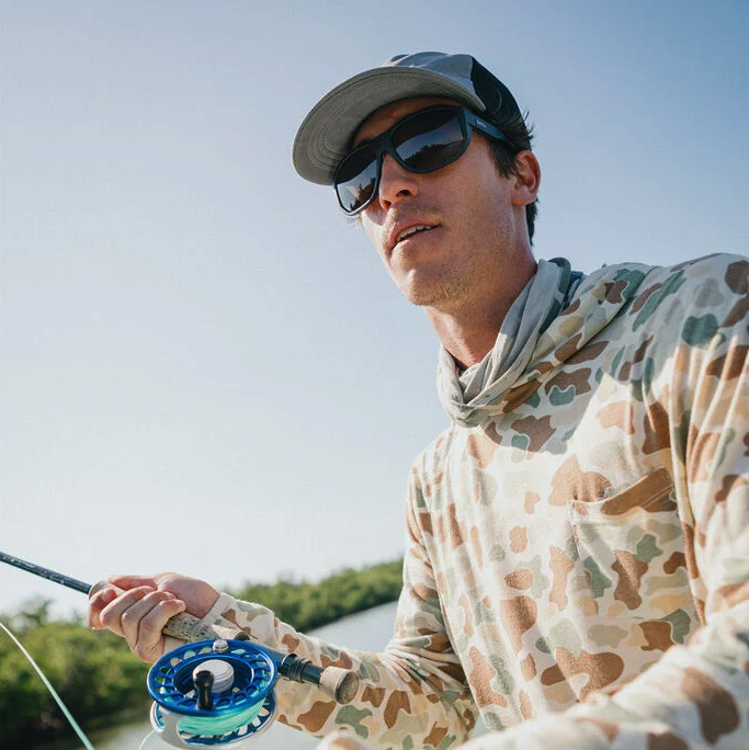Fly angler casting while wearing Smith Outrigger Polarized Sunglasses