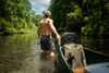 Turtlebox Original Speaker in canoe being pulled up river