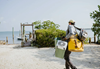 Fly angler carrying Turtlebox Original Speaker to flats boat