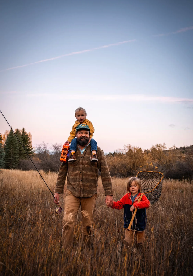 Man and kids walking to fish with Turtlebox Ranger Speaker.