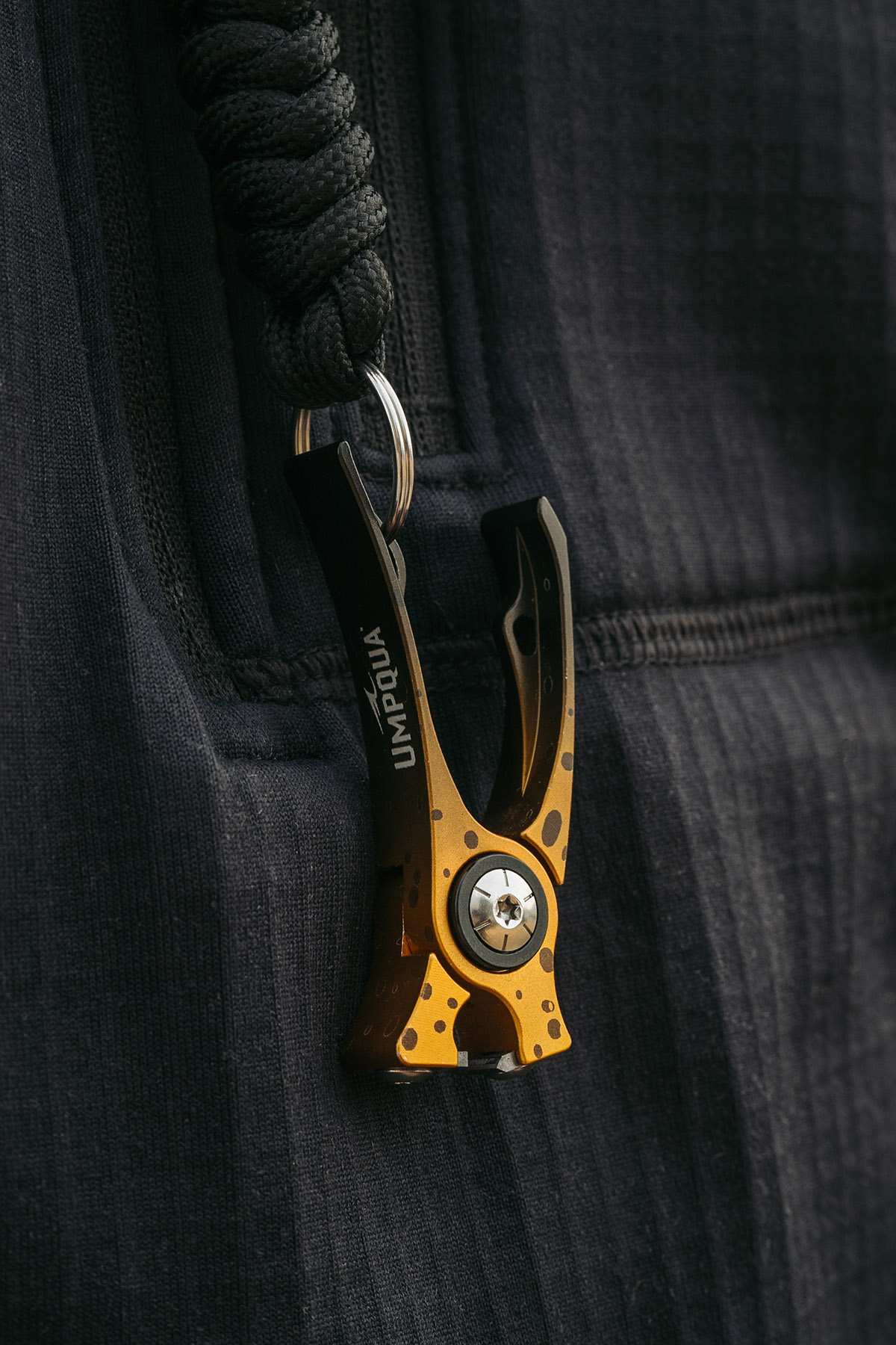 Umpqua RiverRun fly fishing nippers brown trout artist edition clipped to jacket with adjustable lanyard gear setup