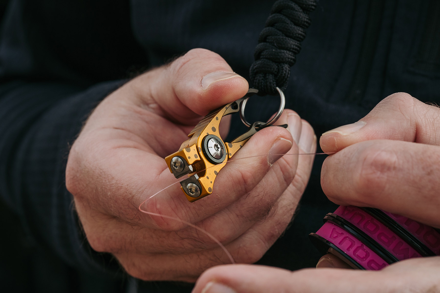 Umpqua RiverRun nippers cutting fly fishing tippet close-up brown trout pattern precision line cutter tool