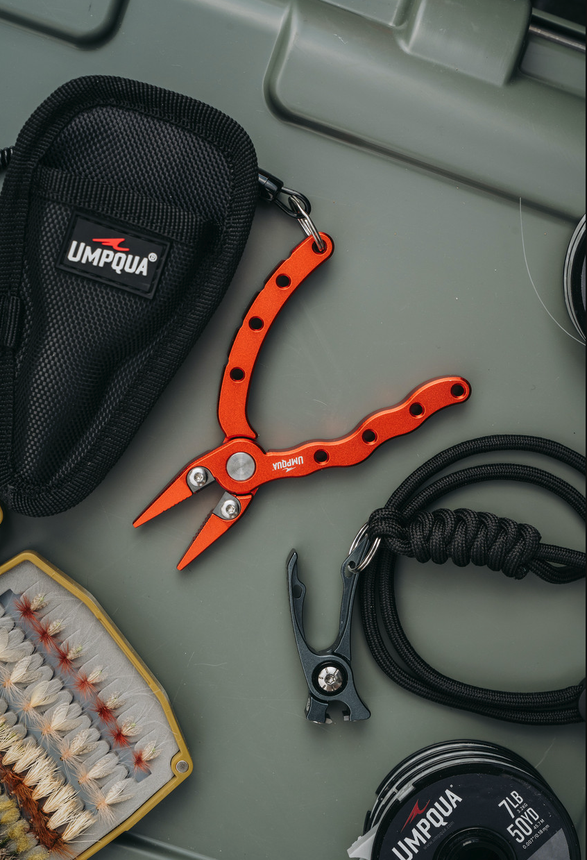 Umpqua RiverRun Pliers and Nippers with lanyard on cooler with fly box and tippet