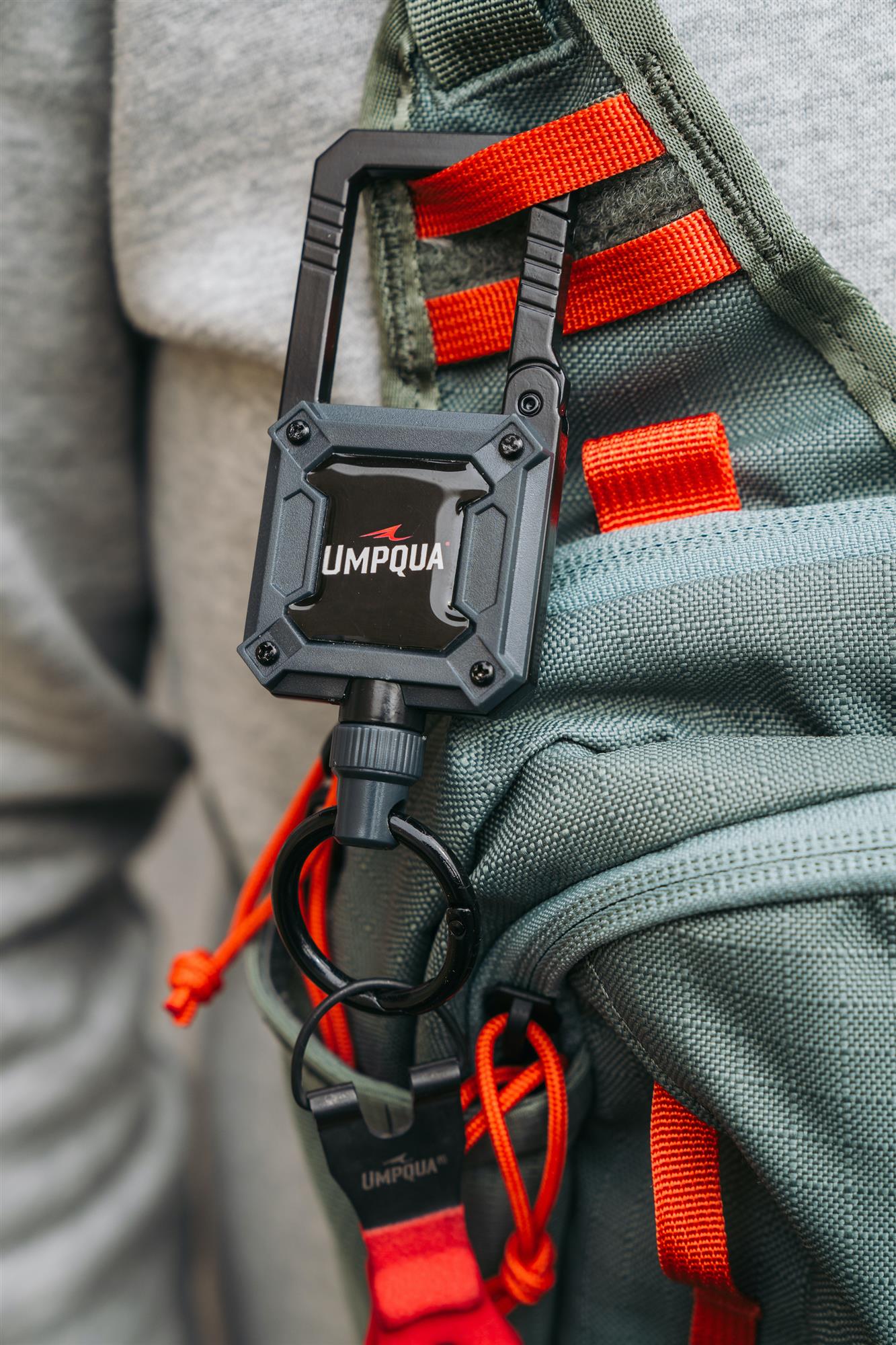 Umpqua RiverRun Large Retractor attached to a fly fishing pack for secure access to pliers and heavy fishing tools