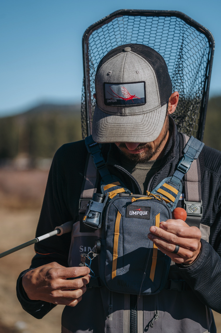 Angler tying line while wearing Umpqua NorthFork Small Chest