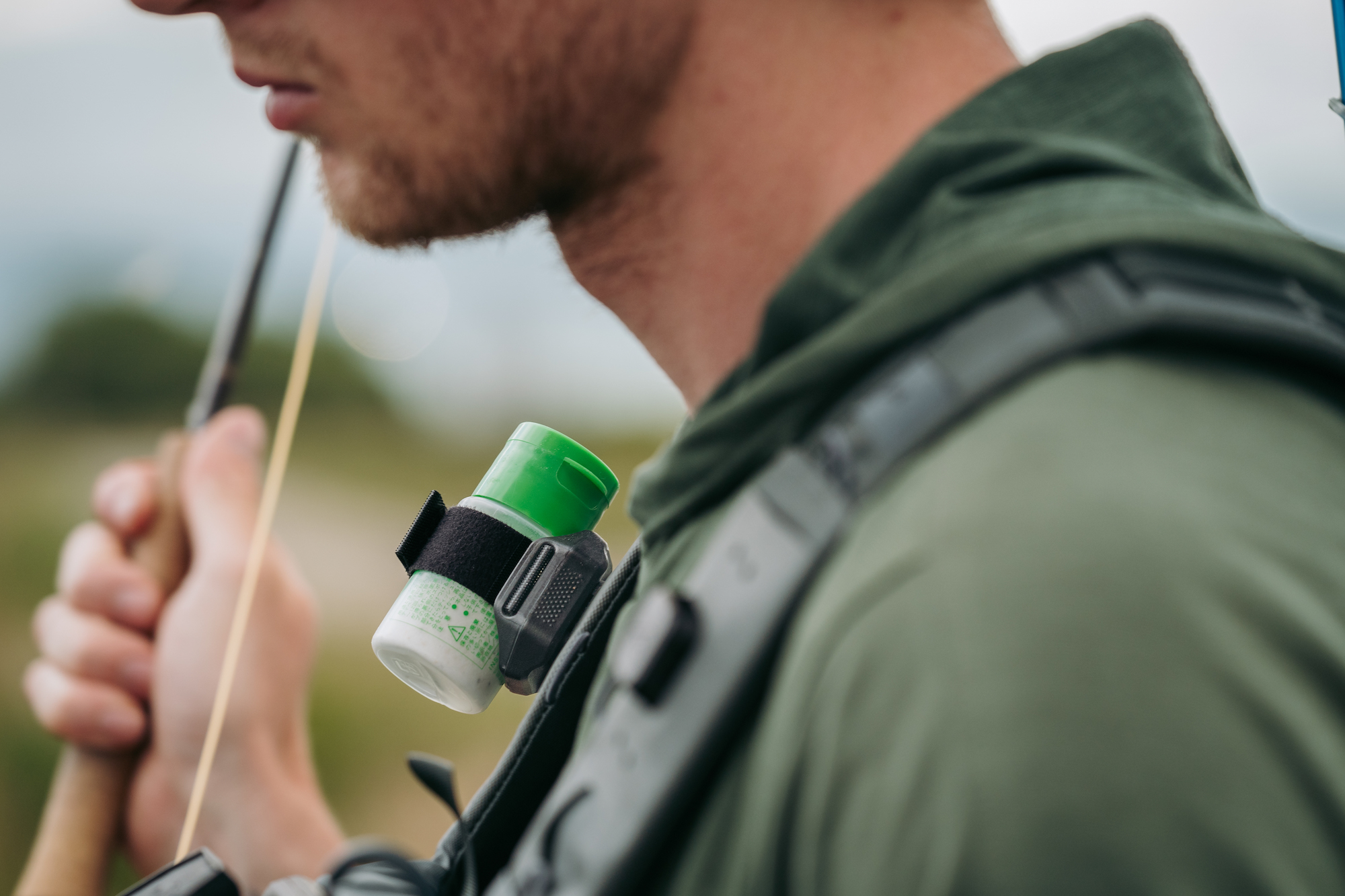 Umpqua LINK floatant holder attached to shoulder strap during fly fishing hands-free access system