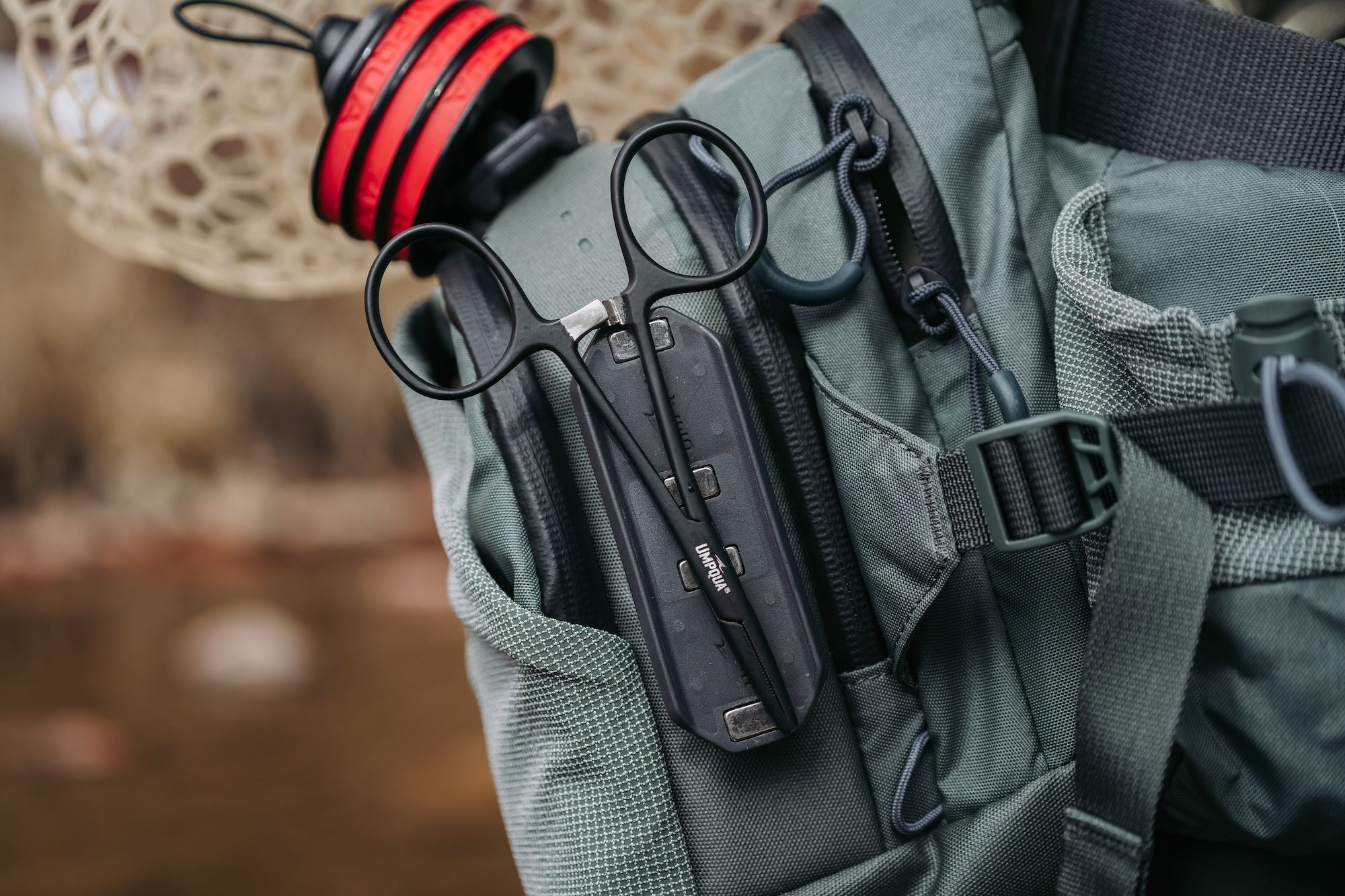 Fly fishing pack setup with Umpqua GearDock holding forceps magnetic modular gear system in use