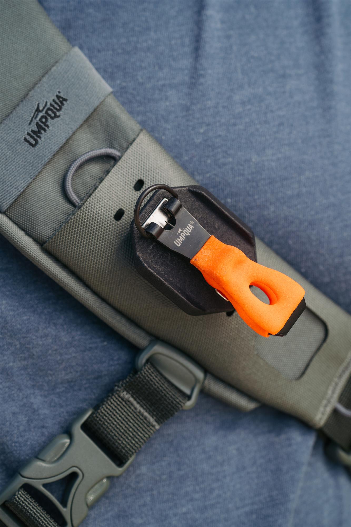 Fly fishing chest pack with Umpqua magnetic nipper holder GearDock modular accessory system