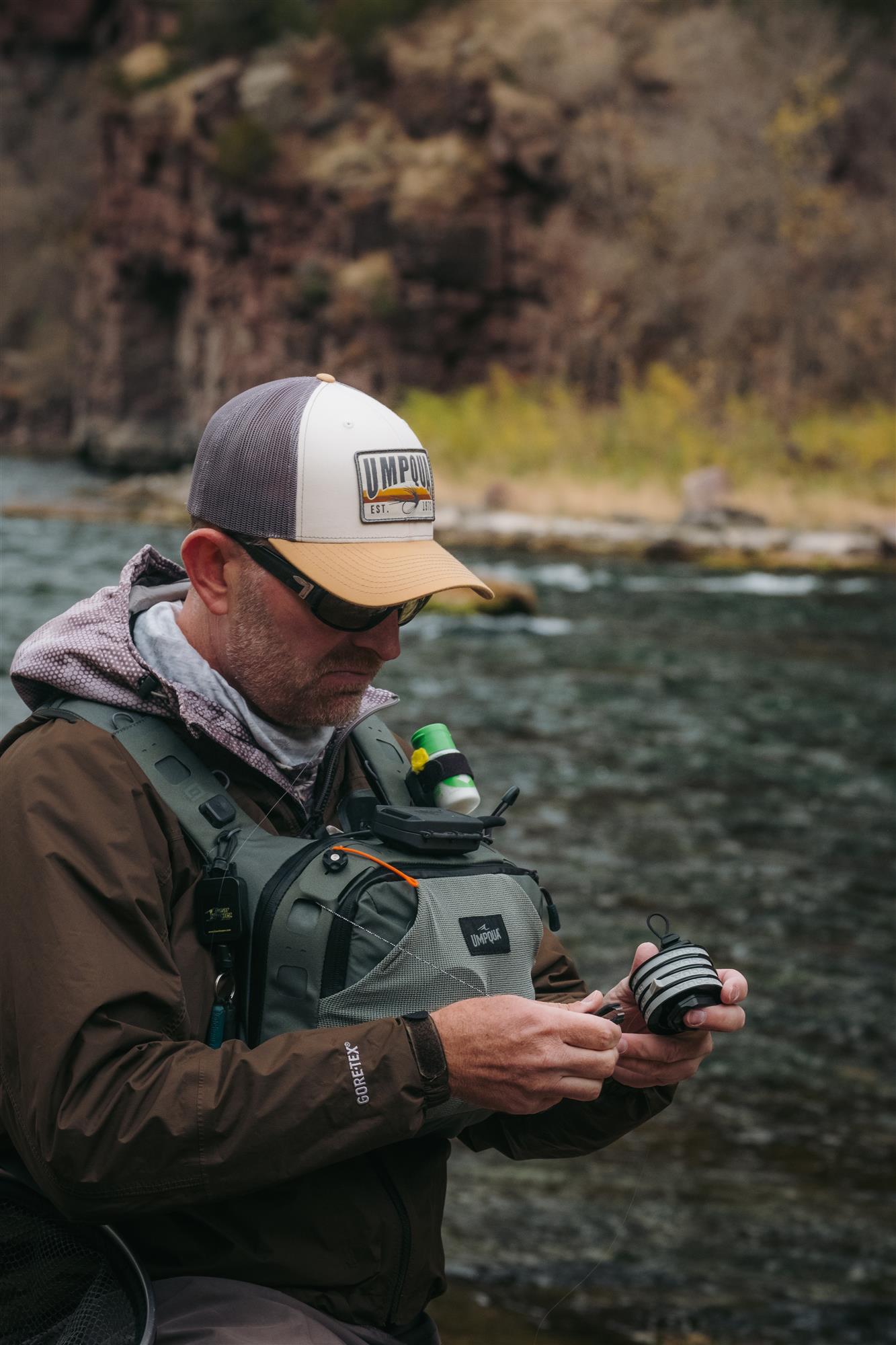 Umpqua LINK Tippet Tower in use streamside with fly fishing gear and modular pack system