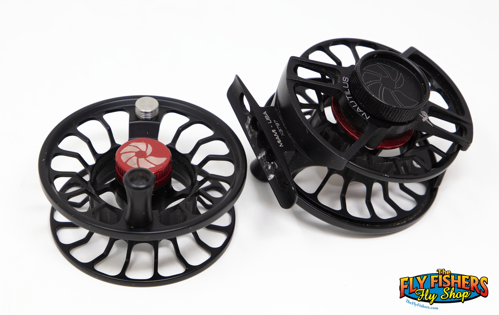 Top sides of Used Nautilus XS Black Fly Reel & Spool laying flat