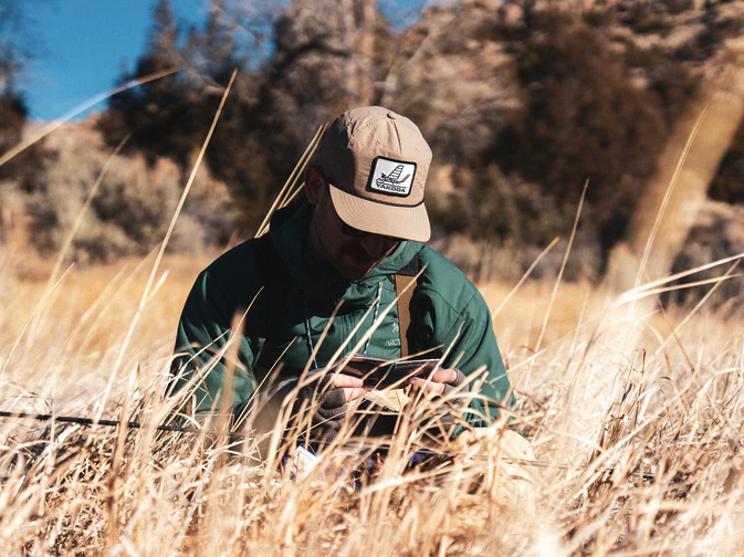Angler fishing in Yakoda Mayfly Patch Hat