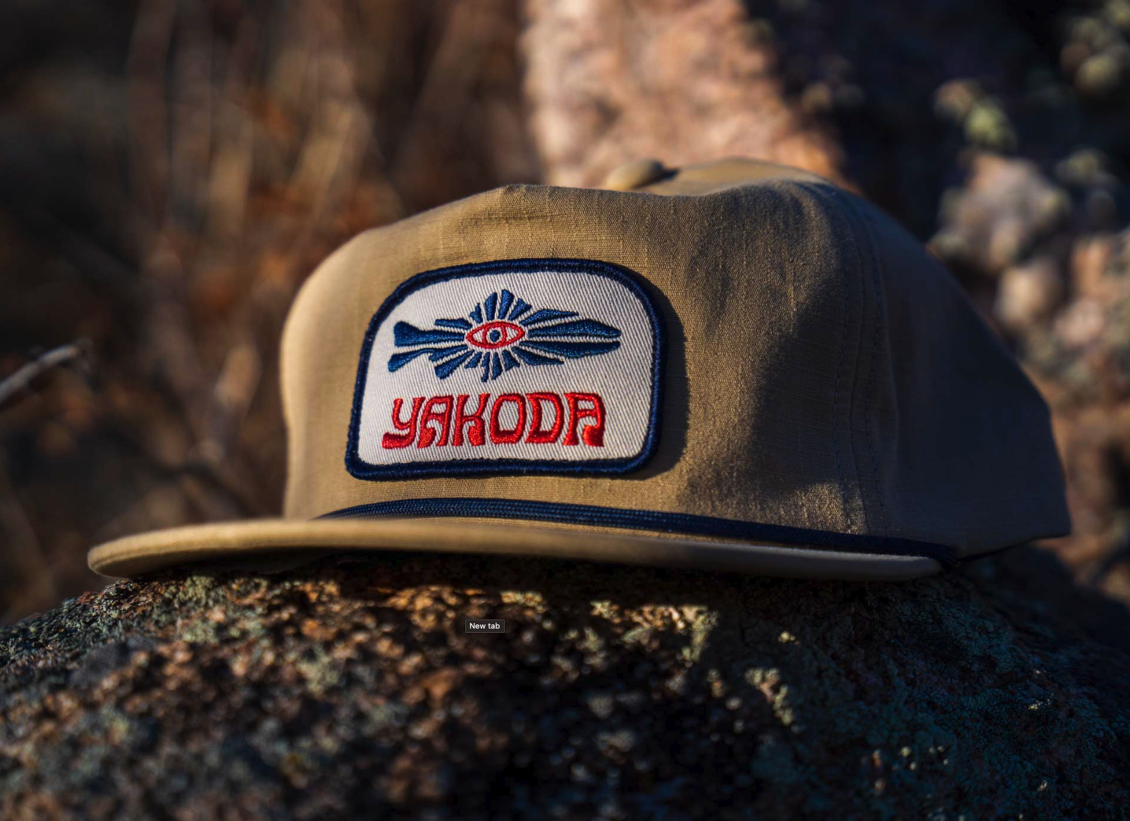 Yakoda Mystic Trout Hat in stone color on a rock.